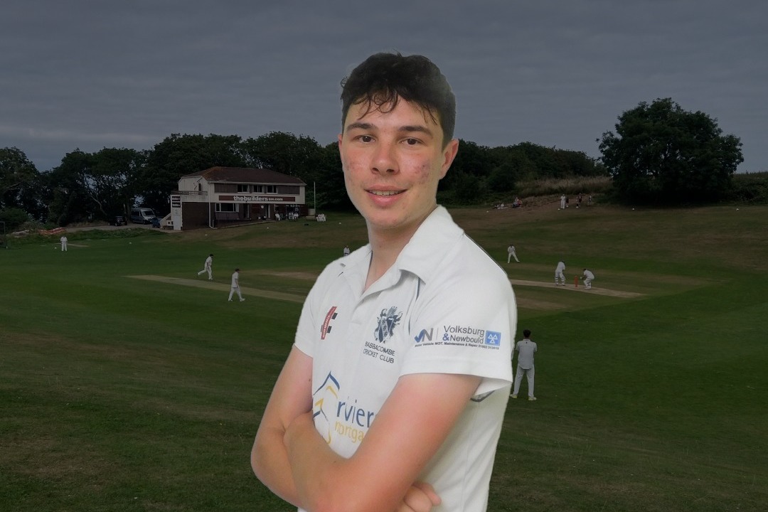 A headshot image of a cricket player with a cricket pitch in the background
